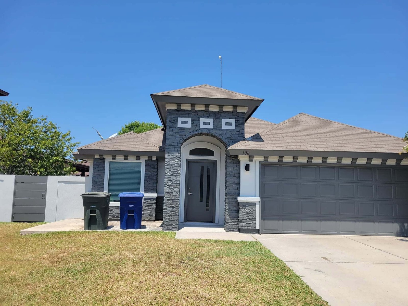 Gray house and garage after exterior painting